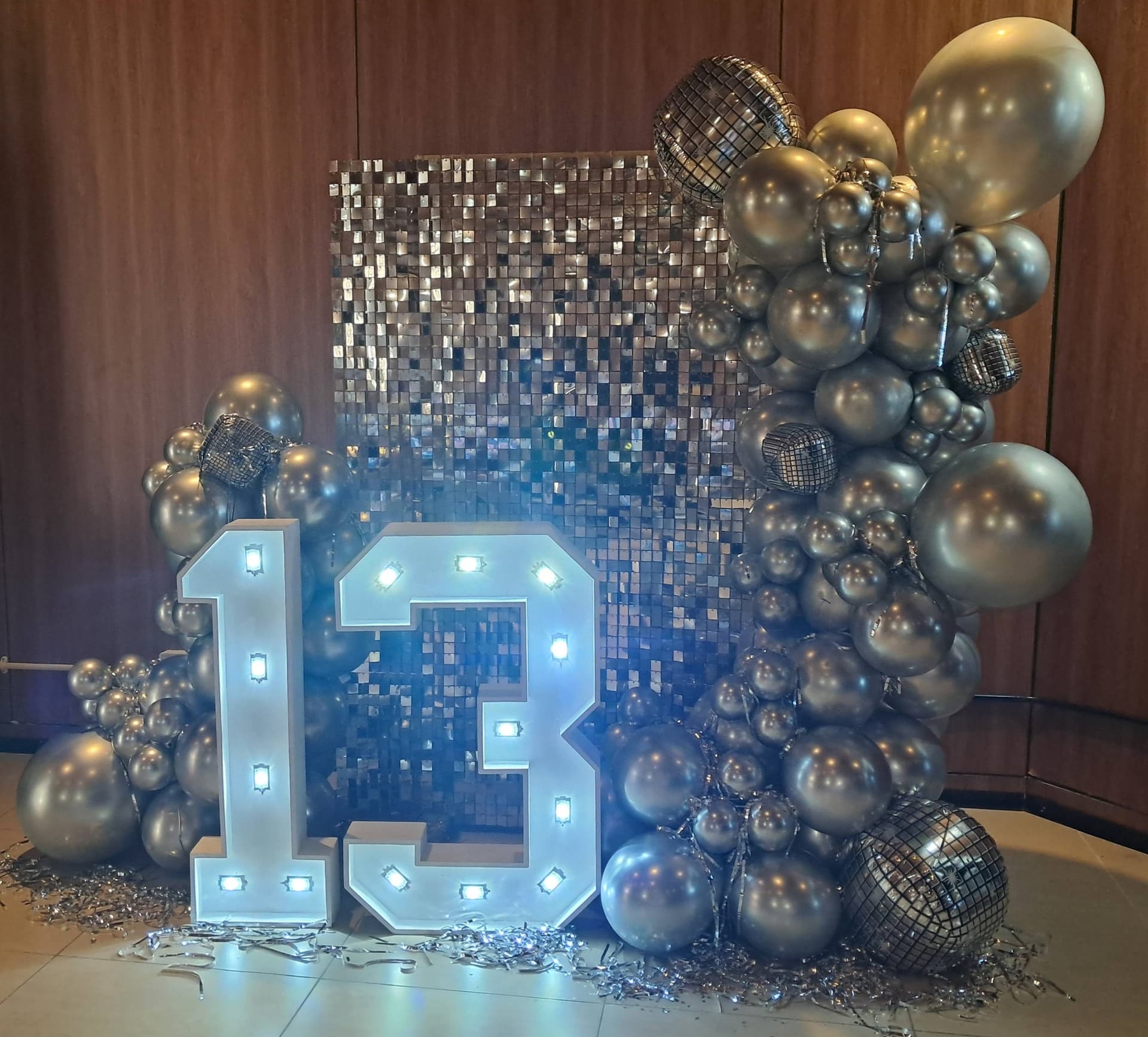 Silver disco themed 13th birthday with light-up numbers and shimmer wall